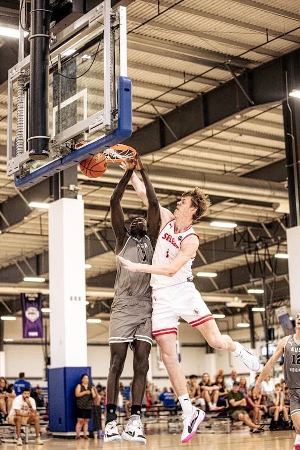 An AUSA Hoops player rising to block a shot at the rim